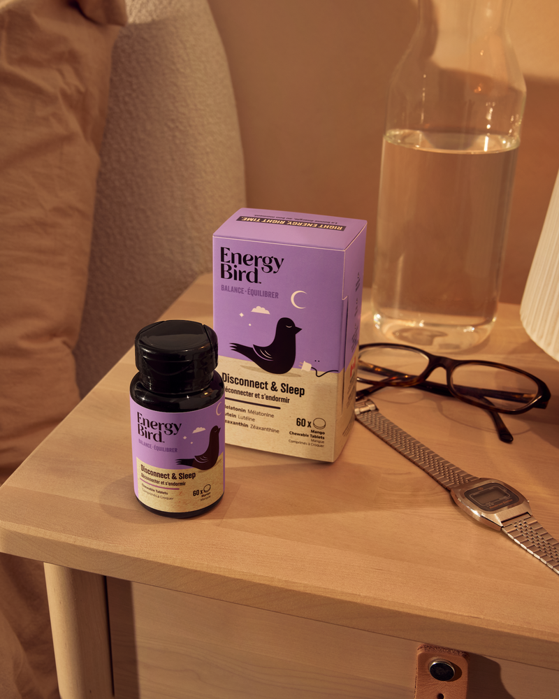 Energy Bird's Disconnect and Sleep bottle and packaging on a nighstand with a watch and glasses on it