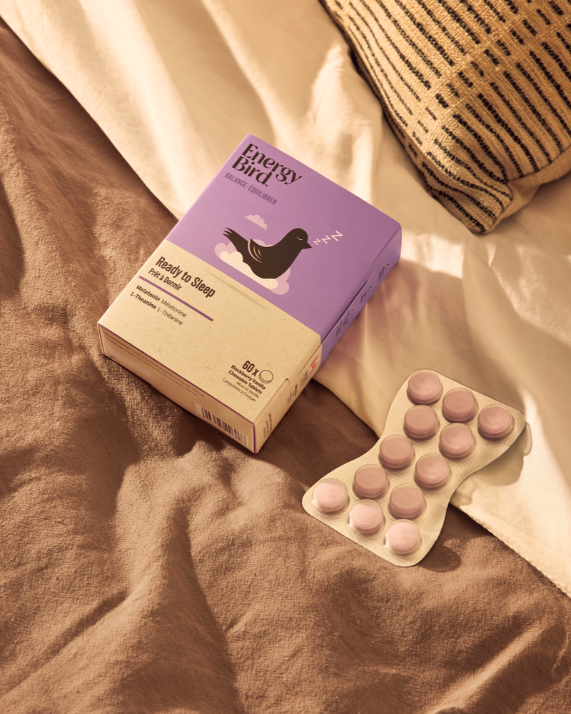 Energy Bird's Ready to Sleep Package and blister pack on a bed with brown blanket