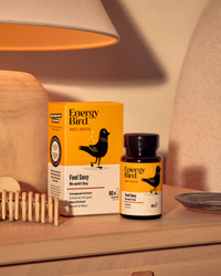 Energy Bird's feel sexy package and bottle on a nightstand beside a lamp