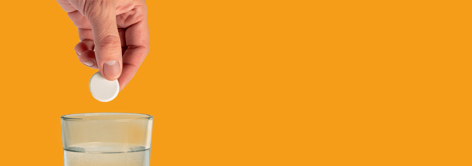 Person dropping boost my energy tablet into glass of water