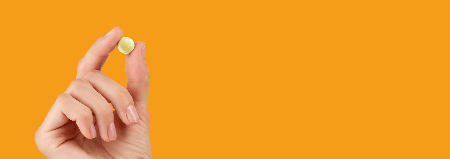 Person holding sharpen my mind pill on orange backgroud