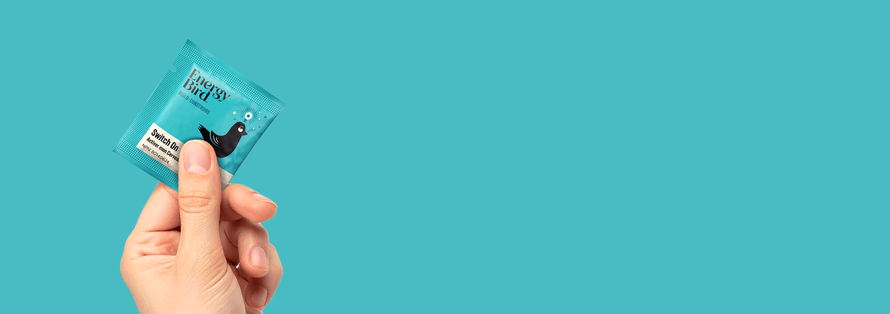 Energy Bird Switch On Sachet being held against a blue background